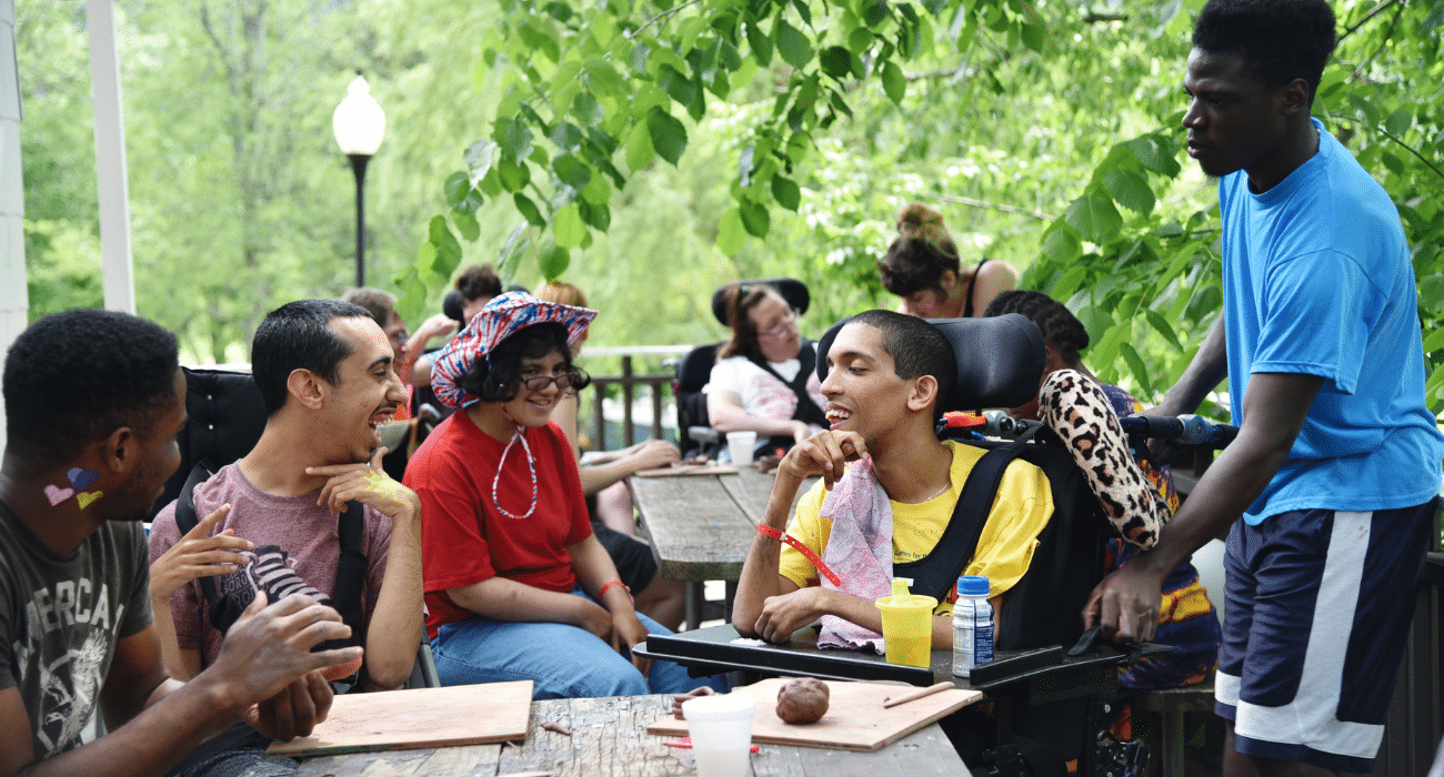 A group of people of all abilities enjoy each other's company at Camp Loyaltown