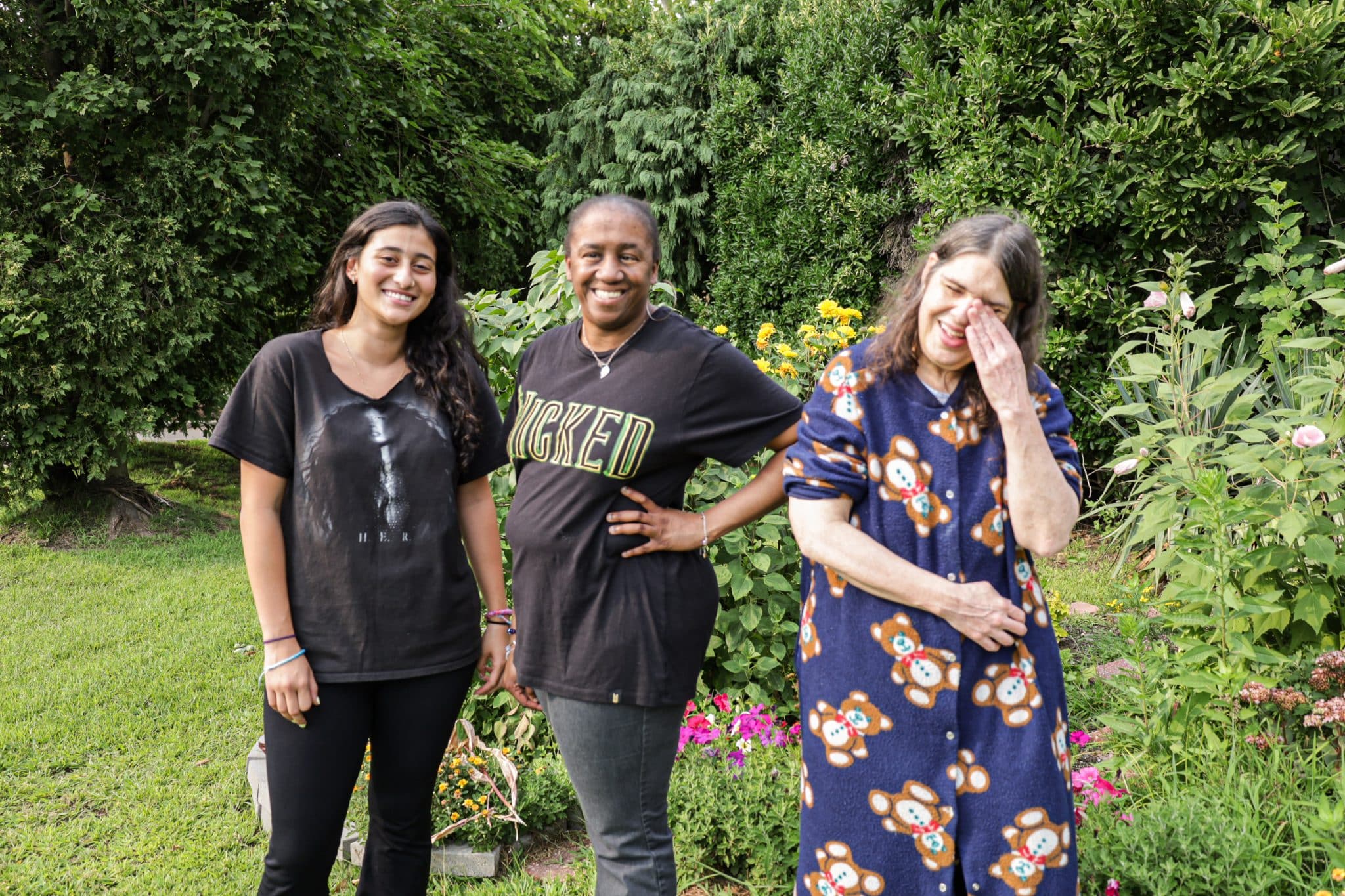 Three Elmwood Lane residents and staff stand in their garden