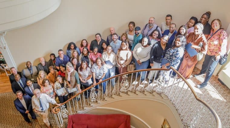 The AHRC Nassau Employees of the Quarter gather on the stairs of the Brookville Mansion