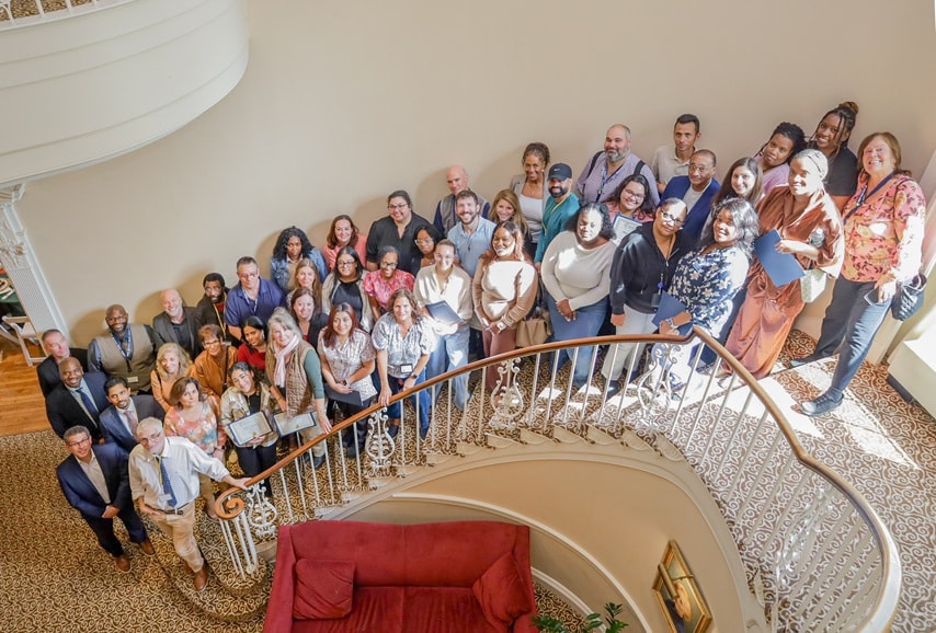 The AHRC Nassau Employees of the Quarter gather on the stairs of the Brookville Mansion