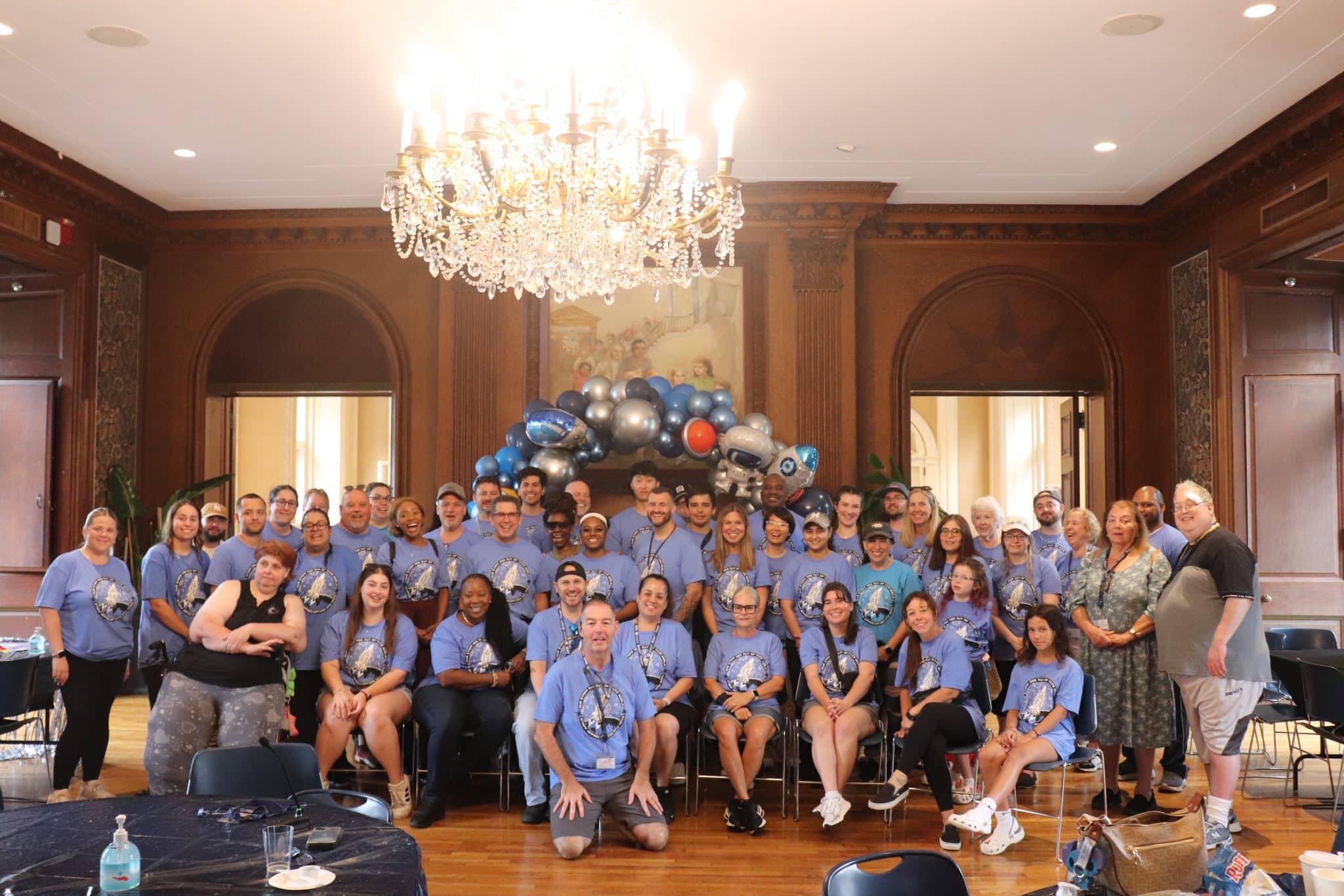 AHRC Nassau staff members gathered in the ballroom in matching shirts on Staff Appreciation Day