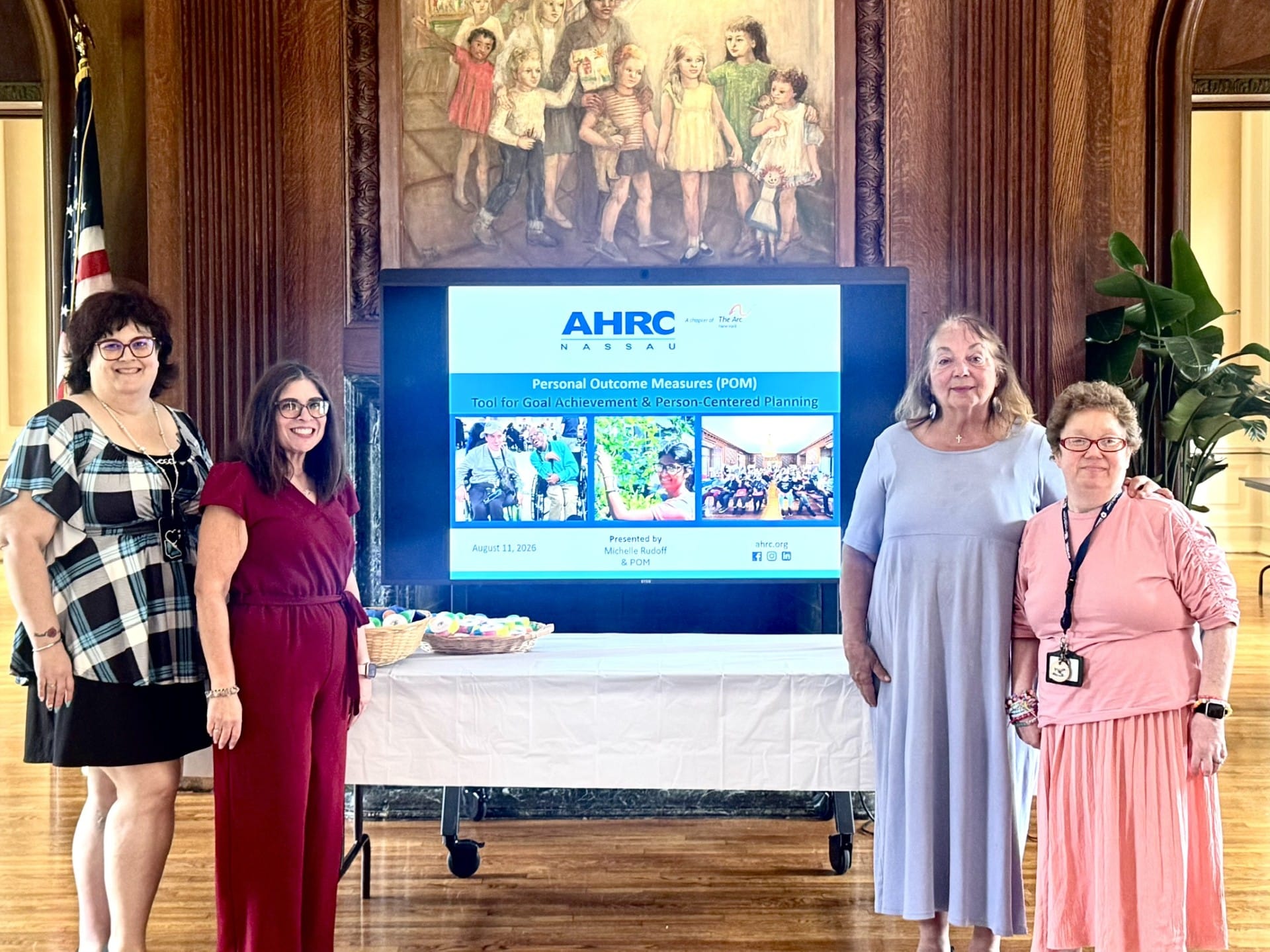 Mchelle and members of her support team stand  alongside Michelle's InformMe presentation.