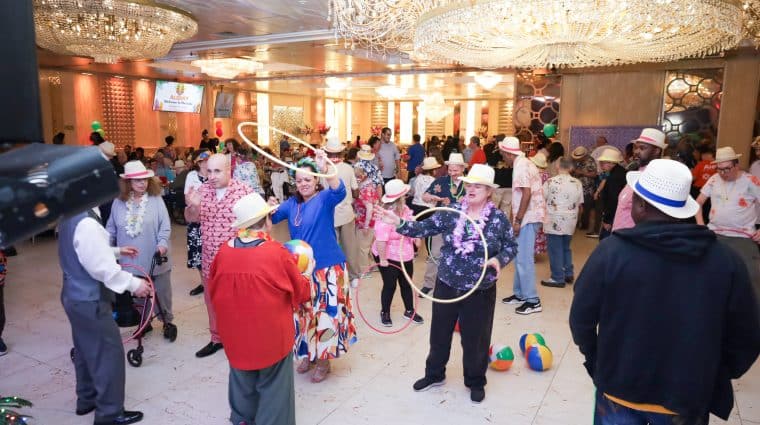 Attendees of the luau dance and play with hoola hoops on the dfance floor