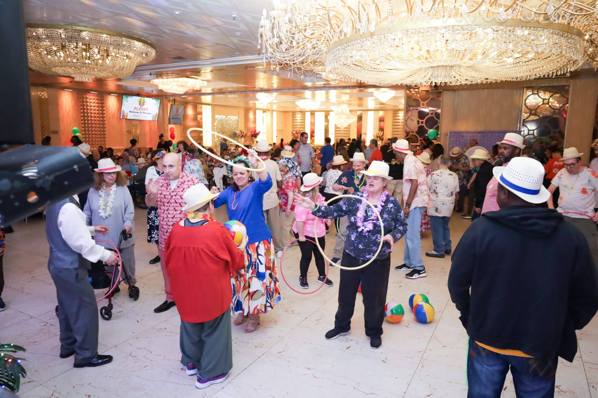 Attendees of the luau dance and play with hoola hoops on the dfance floor