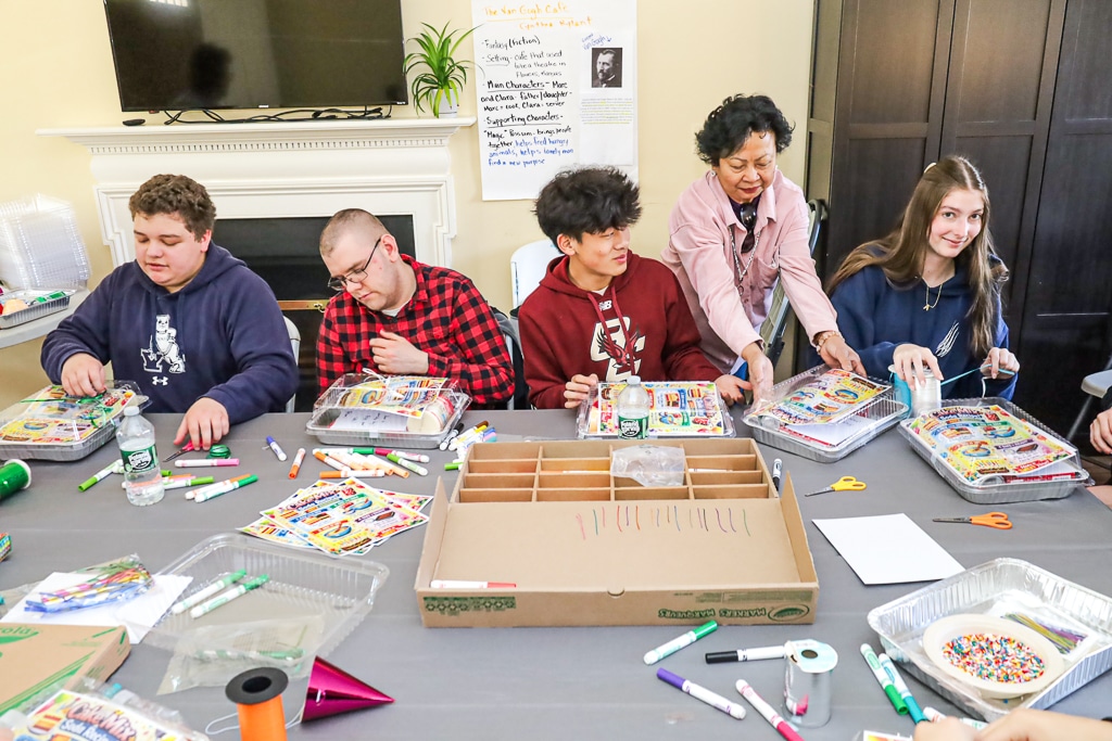 Portledge students and people supported by AHRC Nassau make birthday kits at Wheatley Farms & Arts Center