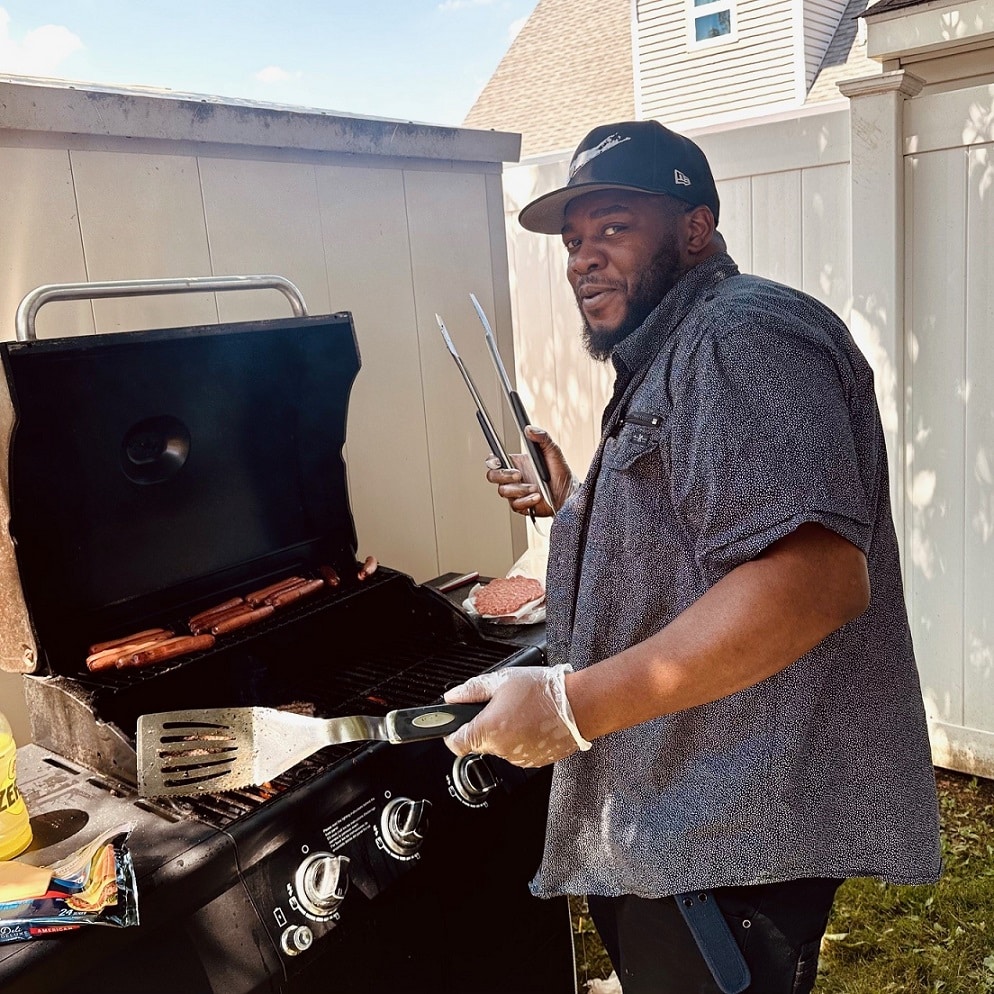 DSP Glen King grills up some food at the tropical-themed summer party