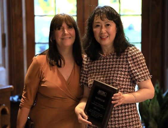 Jerri Walker and Sandia Lu pose with Sandia's award at the volunteer dinner